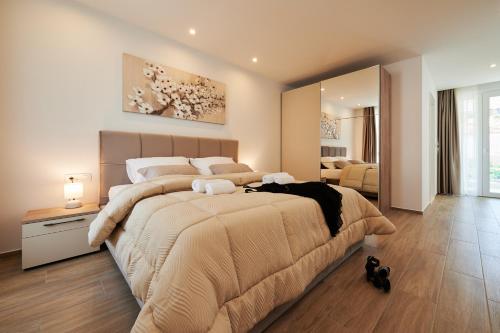 a large bedroom with a large bed and a mirror at Villa Trogir 2 in Trogir