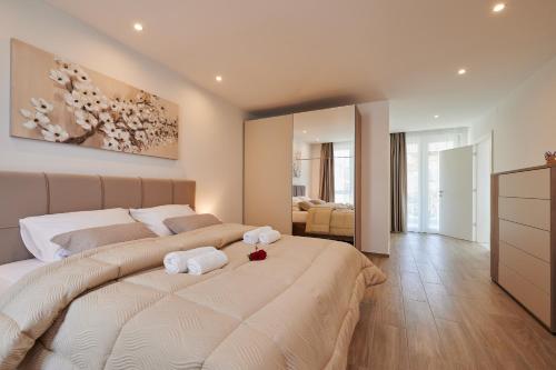 a bedroom with a large bed with towels on it at Villa Trogir 2 in Trogir