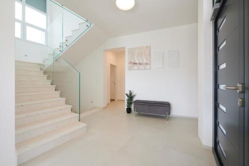 a white hallway with stairs and a glass door at Villa Trogir 2 in Trogir