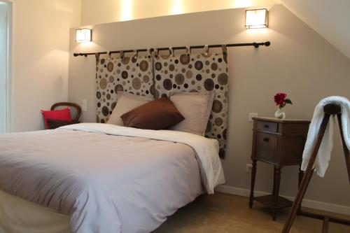 a bedroom with a large bed and a wooden headboard at La Ferme du bois Paris in Ermenonville-la-Petite