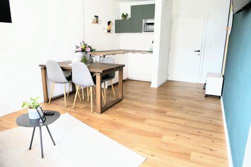 a kitchen and dining room with a table and chairs at NEST'L Appartements & Zimmer in Mösern