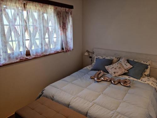 a bedroom with a large bed with a window at Podere I Ripidi in Vicchiomaggio