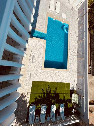 an overhead view of a swimming pool with lounge chairs at Villa Jelena in Trebinje