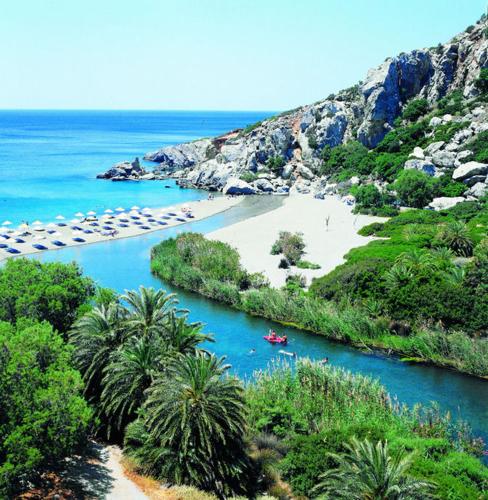 a river with a beach and a boat in it at Villa Margarita's farm, private pool in Maláthiros