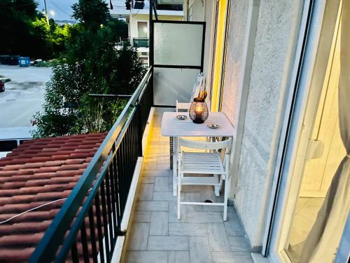 Biały stół i krzesła na balkonie w obiekcie Chryssa’s Studios Deluxe (5 visitors) A2 w mieście Patras