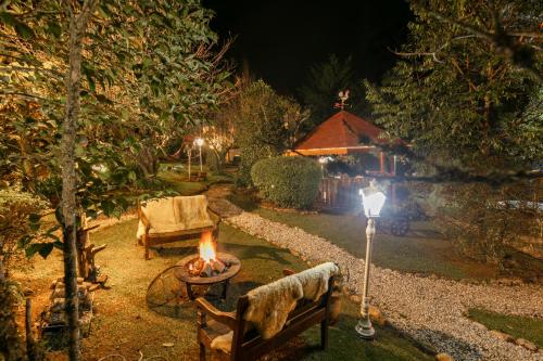 a fire pit in front of a house at night at Pousada das Hortênsias in Campos do Jordão