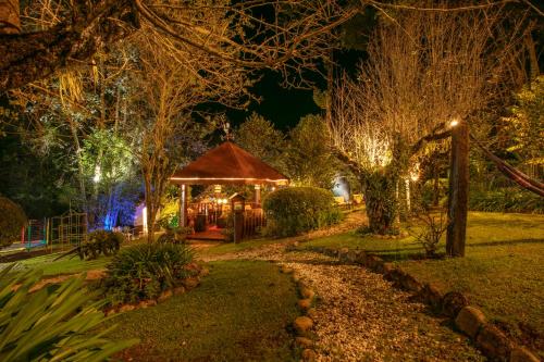 a gazebo with lights in a park at night at Pousada das Hortênsias in Campos do Jordão