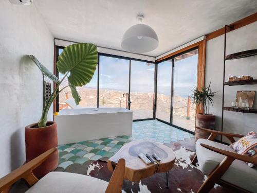 een woonkamer met een tafel en uitzicht op de woestijn bij Native Residence in Rosarito