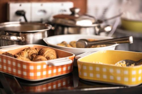 a group of trays of food on a counter at Pousada das Hortênsias in Campos do Jordão