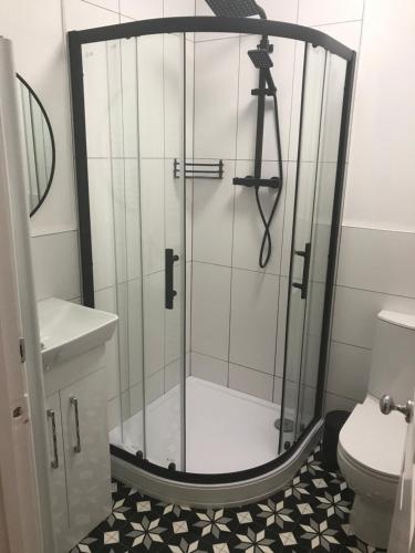 a glass shower in a bathroom with a toilet at * POPULAR * Stunning quiet apartment by the sea in Torquay