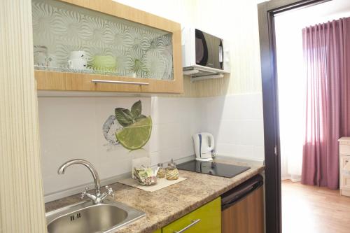 a kitchen with a sink and a counter top at Апартаменты на Спортивной in Tolyatti