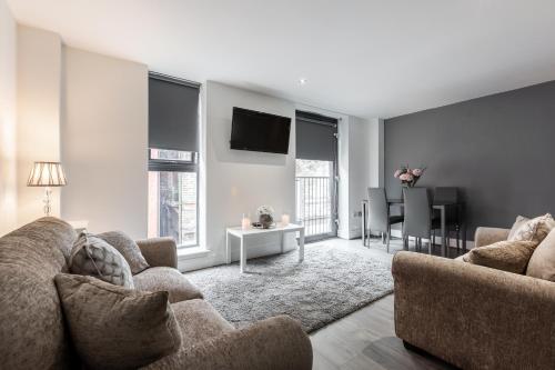 a living room with a couch and a tv at RST Cumberland Street in Liverpool
