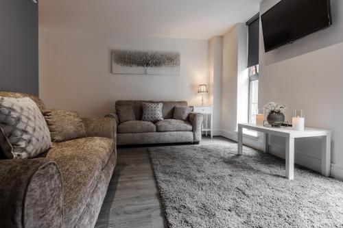 a living room with a couch and a table at RST Cumberland Street in Liverpool