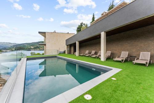 a swimming pool on the side of a house at Gerês Villas in Geres