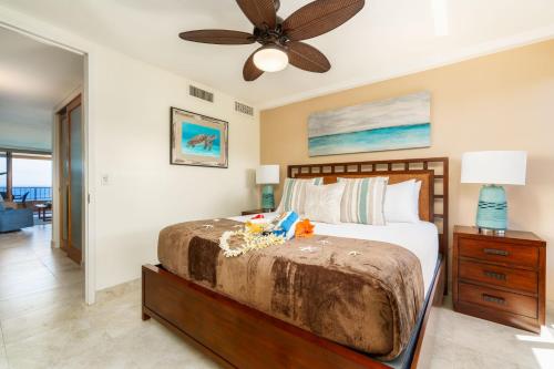 a bedroom with a bed and a ceiling fan at Maui Kai 908 Oceanfront 1 Bedroom condo in Kahana