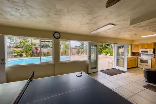 a dining room with a ping pong table in it at Maui Kai 908 Oceanfront 1 Bedroom condo in Kahana