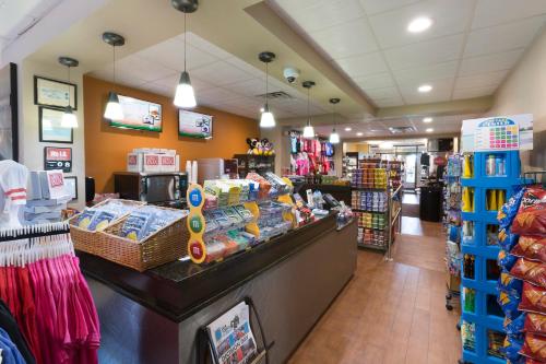 a grocery store aisle with a counter in a store at Rosen Inn Closest to Universal in Orlando