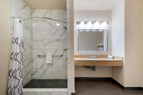 a bathroom with a shower and a sink at Best Western Plus DFW Airport Suites in Irving