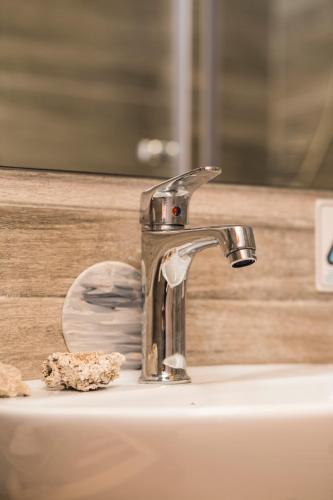 a bathroom sink with a faucet on top of it at CHRISAVGI'S LUXURY HOUSE in Mantoúkion