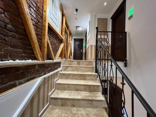 a hallway with stairs and a brick wall at Hotel Boutique Cathedral Plaza Residences room for rent downtown in Bucharest
