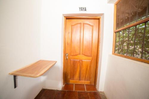 a room with a wooden door and a window at Casa Serrano - Callejón de Don Blas in Mompós