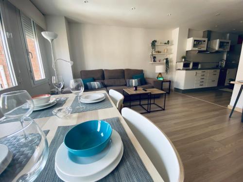 a living room with a dining table and a couch at Fantastic Apartment City Center - Optional Parking in Málaga