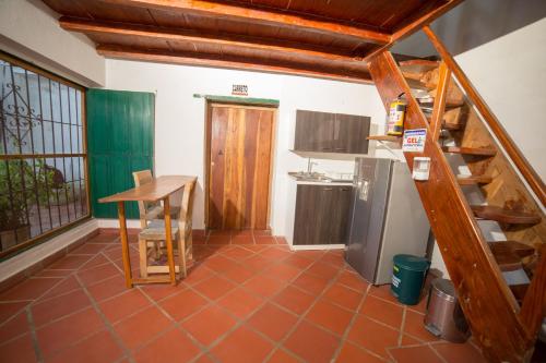 a kitchen with a staircase and a table in a room at Casa Serrano - Callejón de Don Blas in Mompós