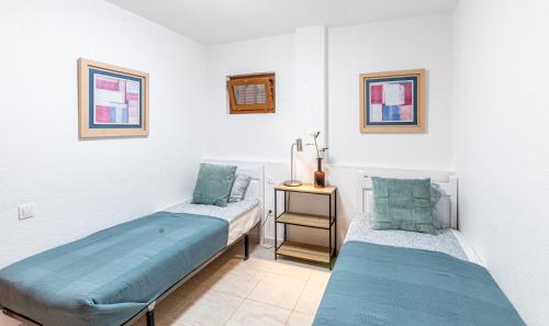 A bed or beds in a room at Los Gigantes Tamara Apartment by Dream Homes Tenerife