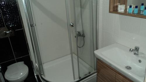 a bathroom with a shower and a sink at Kadikoy Bade 3 Hotel in Istanbul