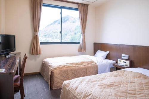Кровать или кровати в номере Hotel Nami