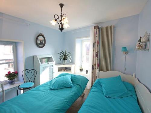 a bedroom with two beds and a desk and a window at Gîte Remiremont, 3 pièces, 4 personnes - FR-1-589-132 in Remiremont