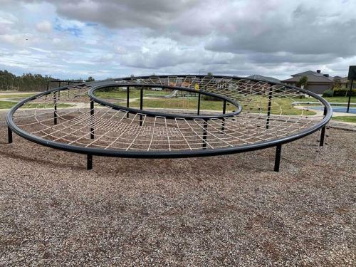 a metal trampoline on the ground in a park at Holiday Rental 6 KING BD 12PPL in Truganina