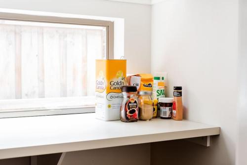 a counter with various food items on a window sill at Holiday Rental 6 KING BD 12PPL in Truganina
