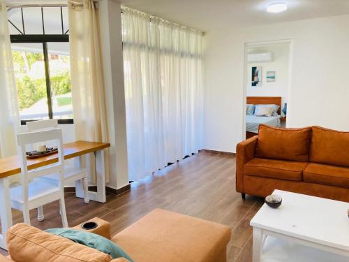 a living room with a couch and a table at Flat Sea & Sun Monte Vista in Sosúa
