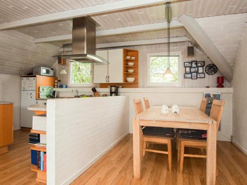 a kitchen with a table and chairs in a room at 4 person holiday home in Ringk bing in Søndervig