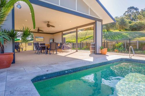 a house with a swimming pool in front of a house at Sovereign Hill Country Estate in Lovedale