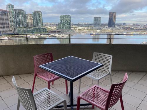 a table topped with chairs next to a water fountain at Accent Accommodation@Docklands in Melbourne