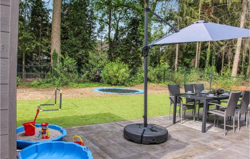 a table with an umbrella on a patio at 3 Bedroom Pet Friendly Home In Epe in Epe