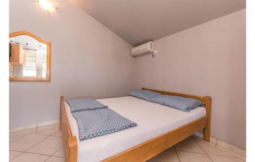 a bed with two pillows on it in a room at Gorgeous Apartment In Kakma With Wifi in Kakma