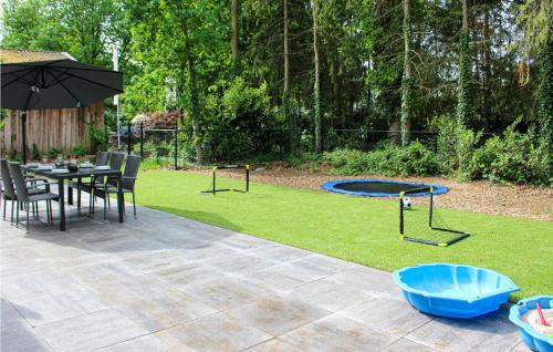 a patio with a table and a trampoline at Cozy Home In Epe With Wifi in Epe