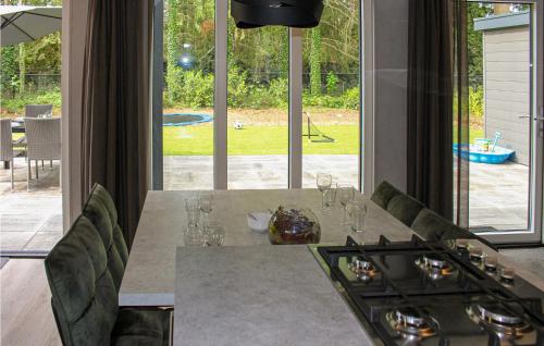 a kitchen with a table with a view of a backyard at Cozy Home In Epe With Wifi in Epe