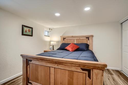 a bedroom with a wooden bed with a wooden headboard at Sloans Lake Getaway - Basement Apartment Near Broncos and Downtown Denver in Lakewood