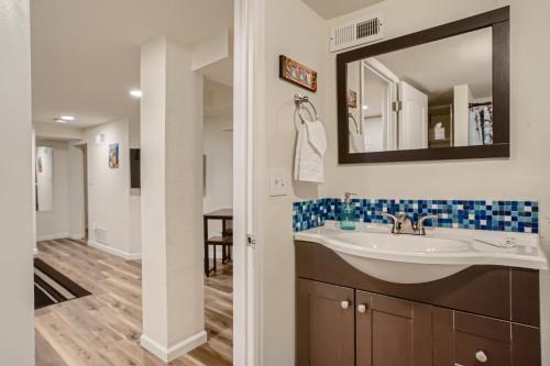 a bathroom with a sink and a mirror at Sloans Lake Getaway - Basement Apartment Near Broncos and Downtown Denver in Lakewood