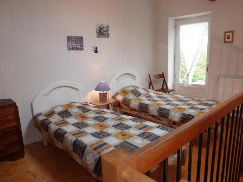 a bedroom with two beds and a window at Charmant gîte avec poêle à bois, terrasse et jardin, sentiers rando, 1 chambre + mezzanine - FR-1-496-256 in Véranne