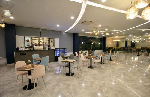 a restaurant with tables and chairs in a room at T Shine Resort and Spa in Mactan