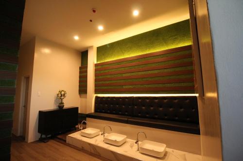a bathroom with two sinks and a large mirror at T Shine Resort and Spa in Mactan