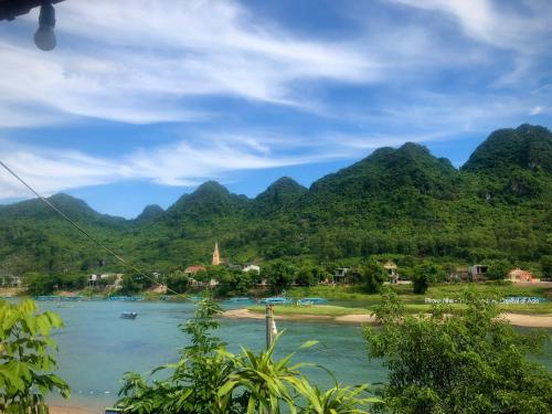 a view of a river with mountains in the background at Areca Bungalow in Phong Nha