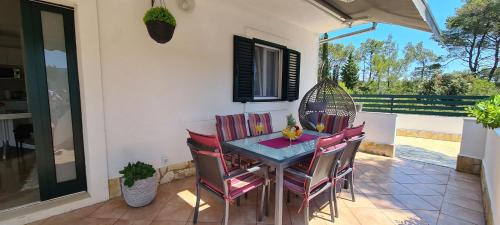 a dining room table and chairs on a patio at House Relaxing oasis in Stari Grad