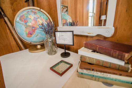 a table with a globe and a stack of books at Jack Room BW Boutique Hotel in Central Lake