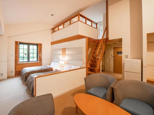 a room with two beds and a loft bed at Tabist Hotel Colosseum Inn Tateshina in Tateshina